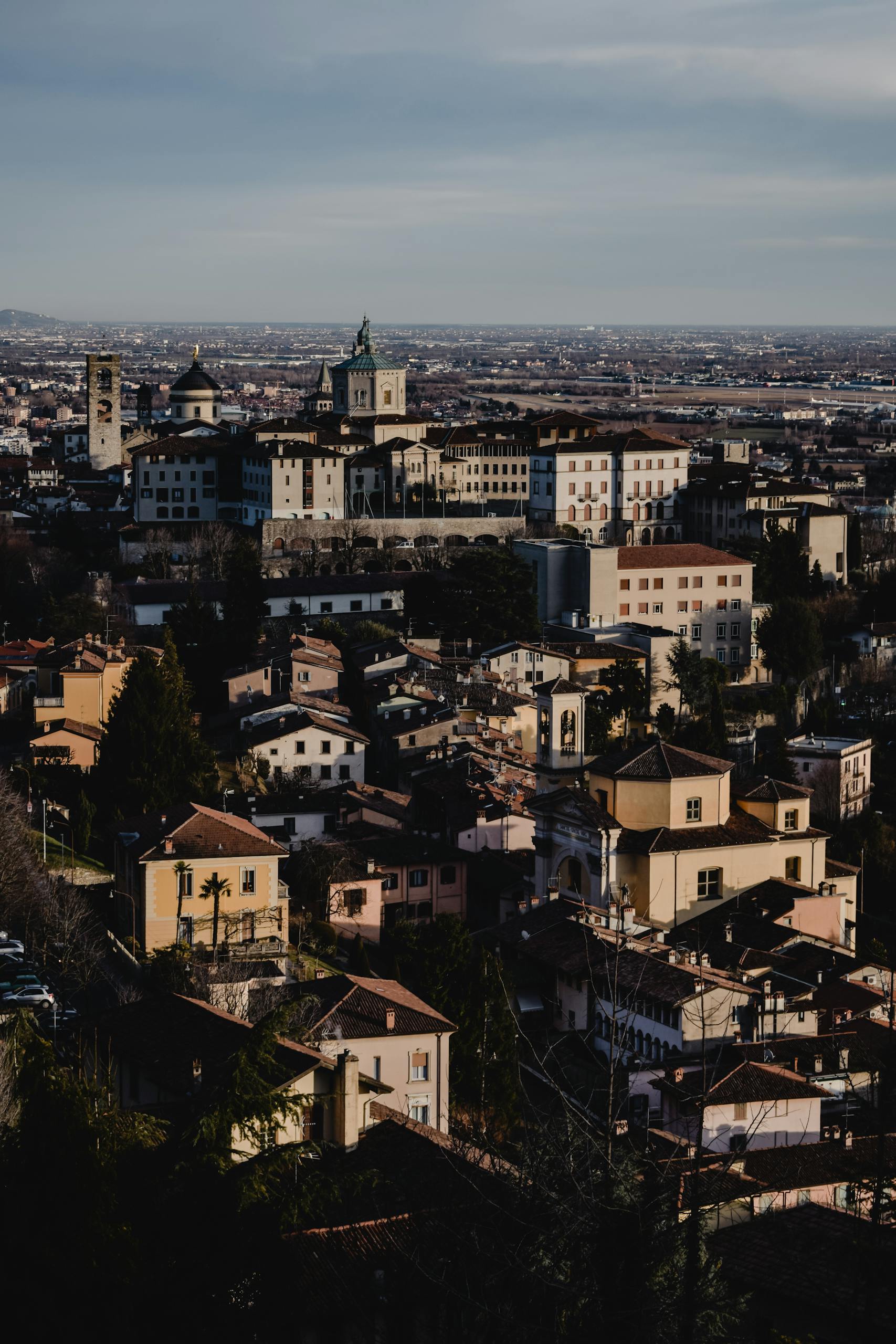 Aerial view of Bergamo, Italy, showcasing its historic architecture under a clear sky.